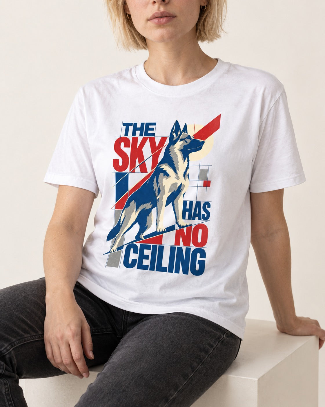 Sky Has No Ceiling German Shepherd Dog T-Shirt in White, worn by a seated model