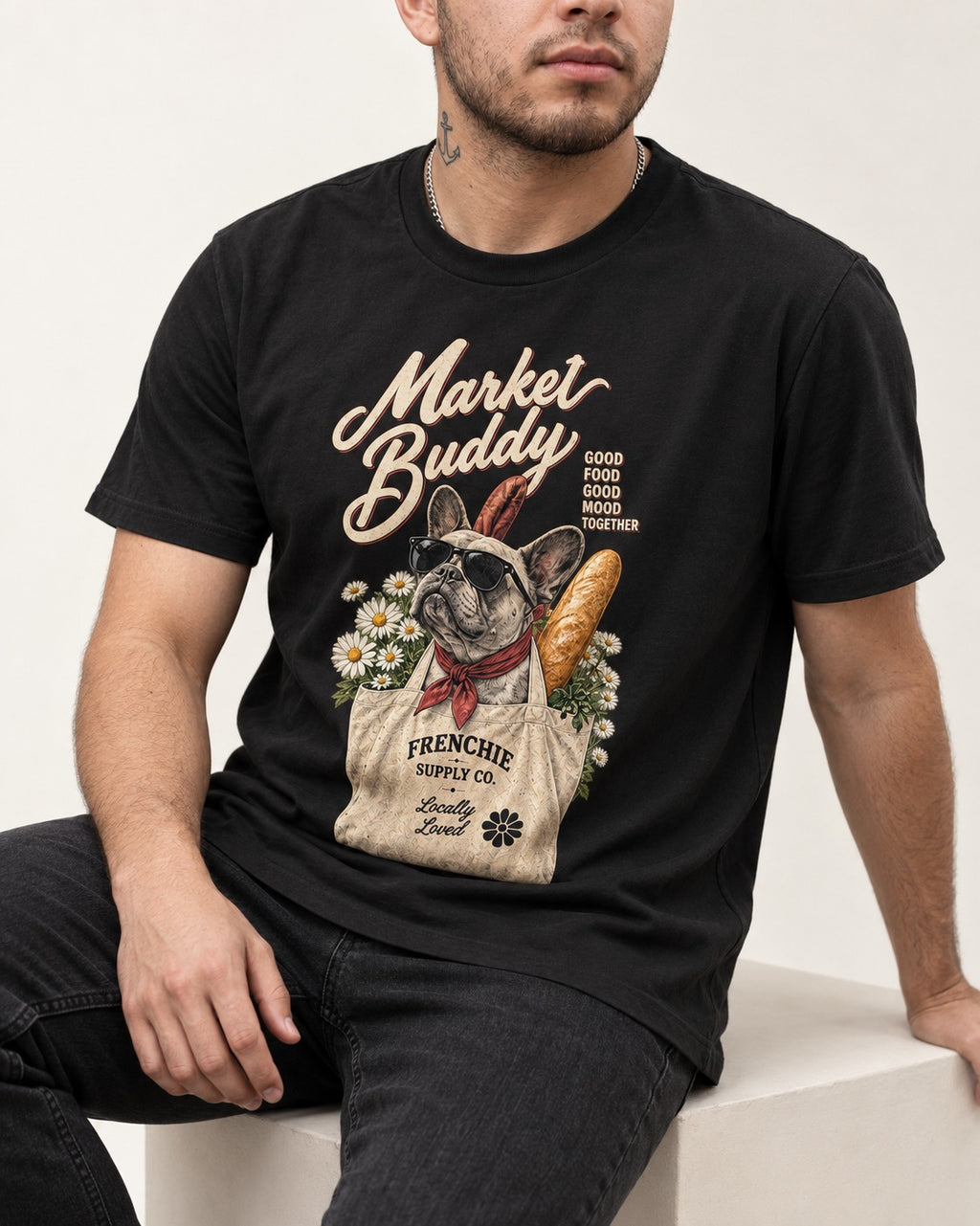 Frenchie Market Buddy Grocery Tote Graphic T-Shirt in Black, worn by a seated model