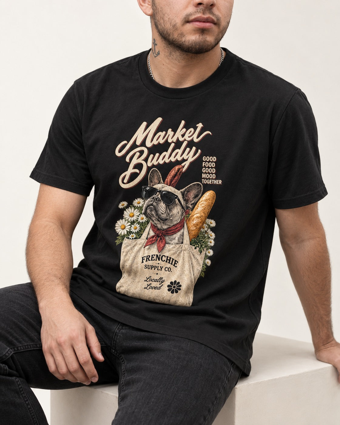 Frenchie Market Buddy Grocery Tote Graphic T-Shirt in Black, worn by a seated model