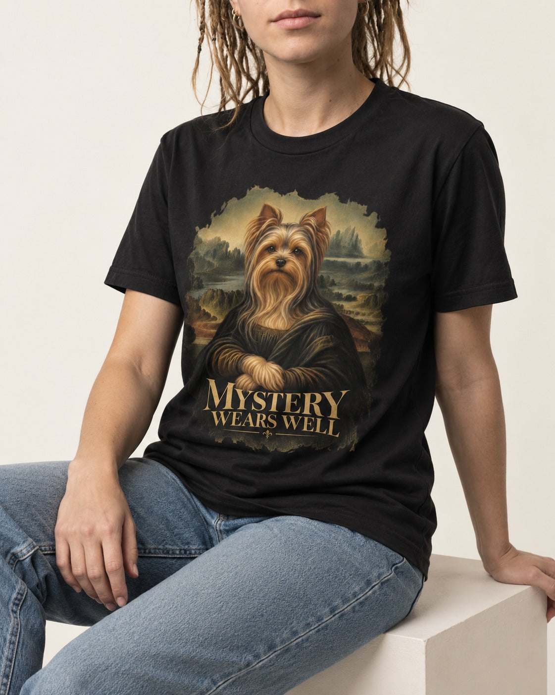 Yorkshire Terrier Mystery Wears Well Mona Lisa Portrait Graphic T-Shirt in Black, worn by a seated model