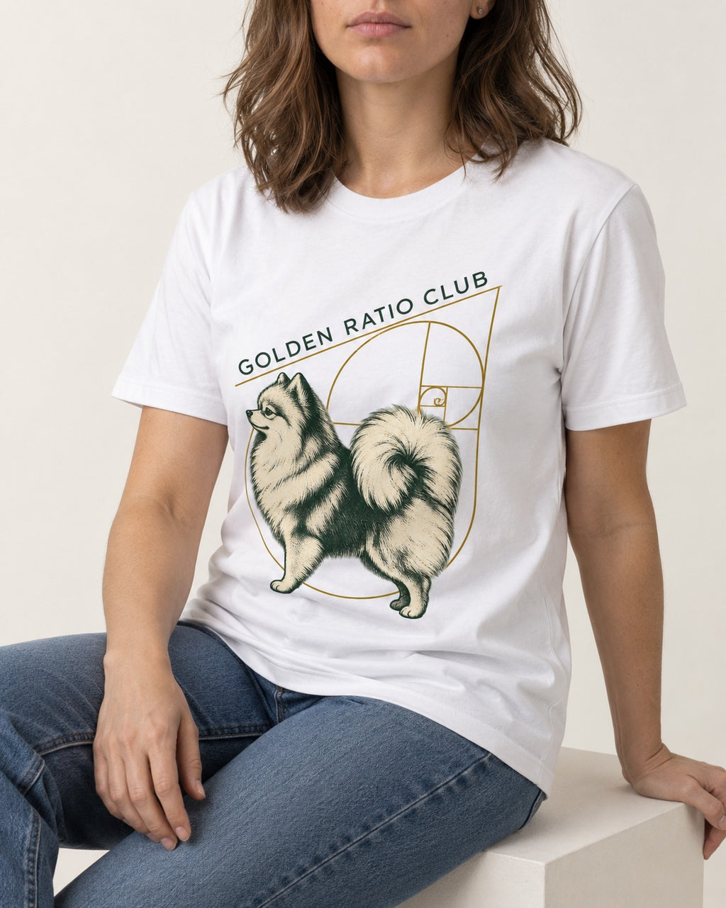 Pomeranian Golden Ratio Club T-Shirt in White, worn by a seated model