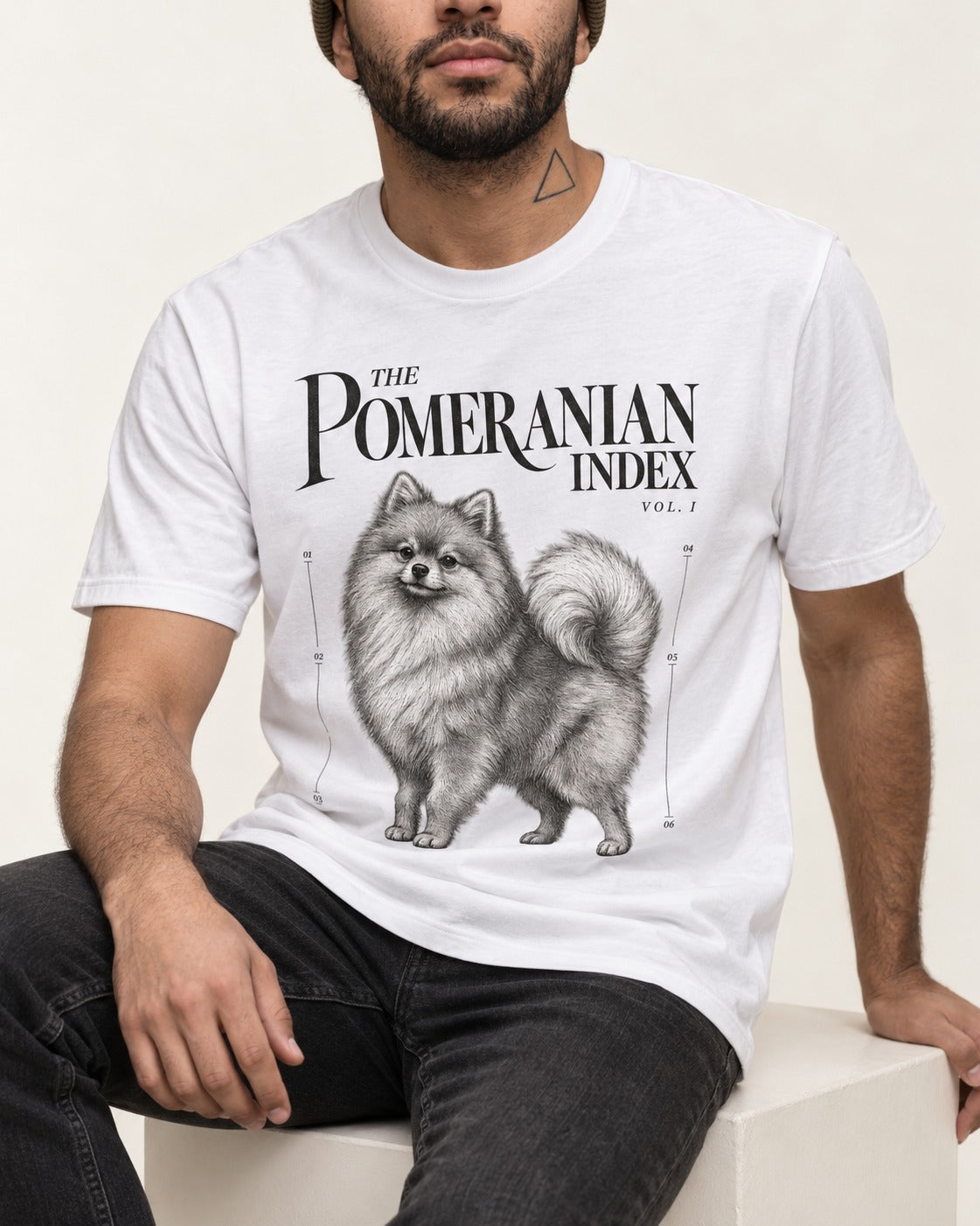 The Pomeranian Index T-Shirt in White, worn by a seated model