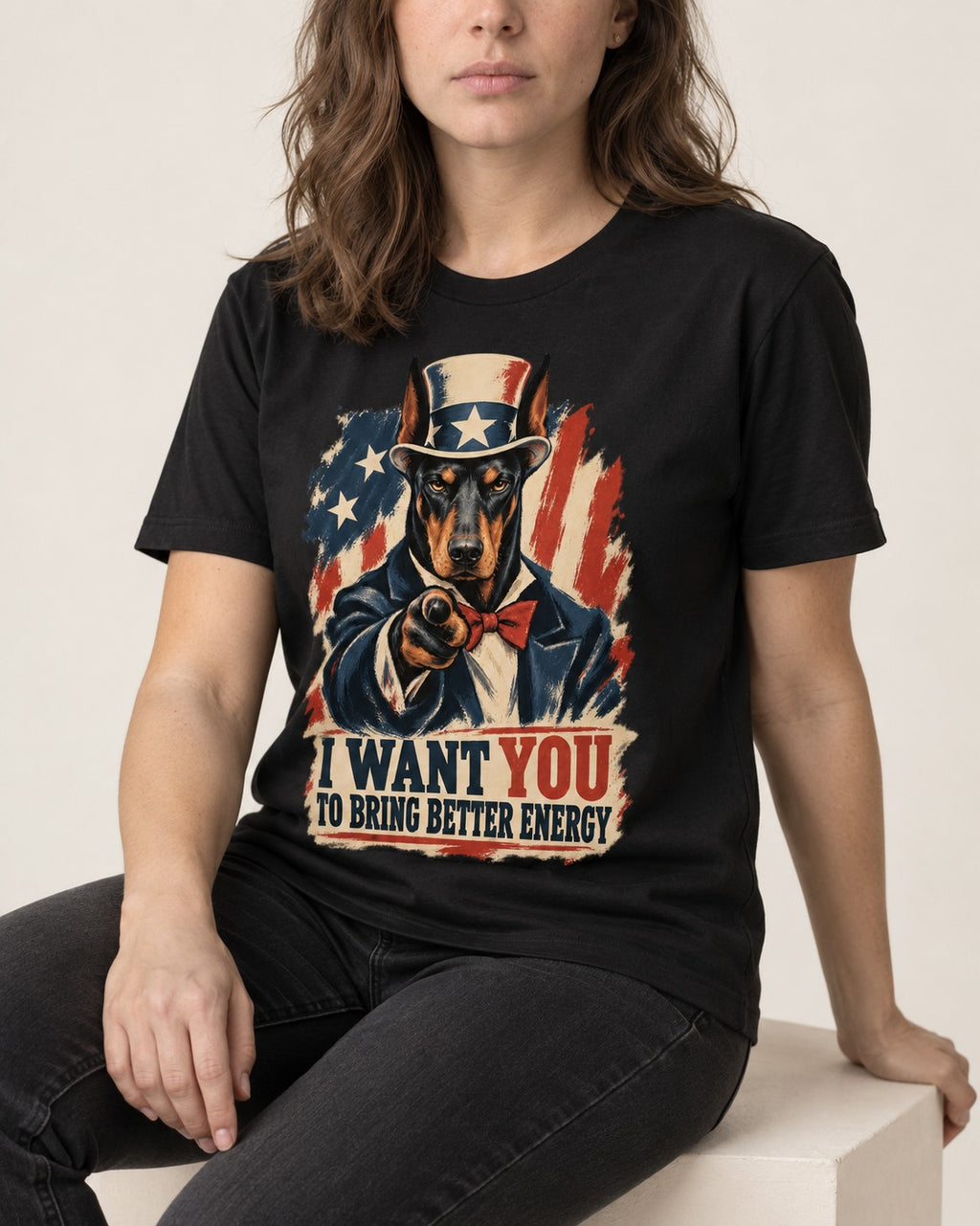 Doberman I Want You to Bring Better Energy Uncle Sam Graphic T-Shirt in Black, worn by a seated model