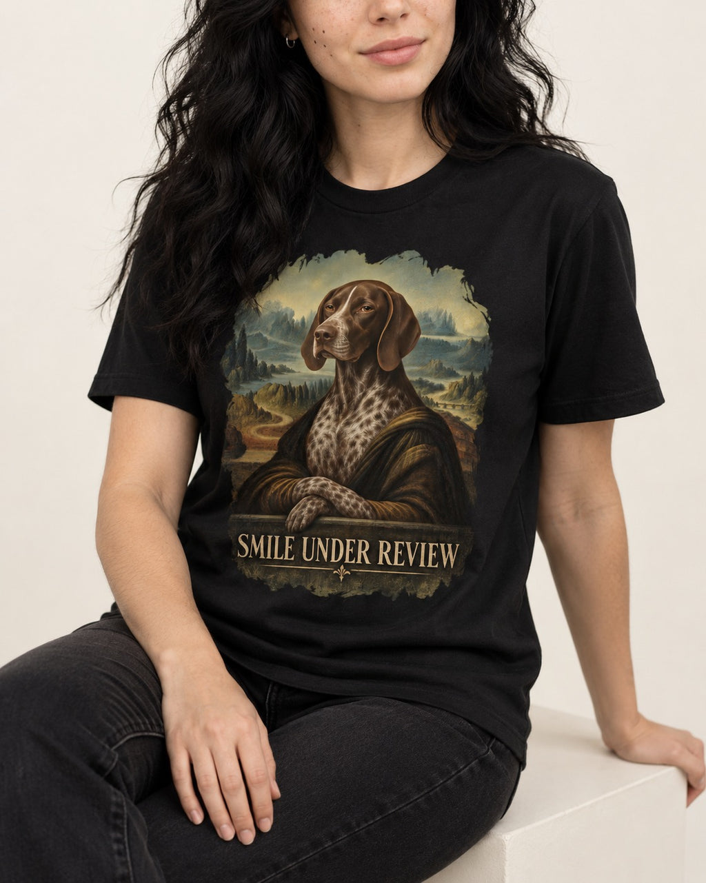 German Shorthaired Pointer Smile Under Review Renaissance Portrait Graphic T-Shirt in Black, worn by a seated model