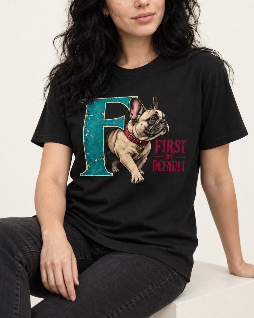 Frenchie First by Default Teal F Graphic T-Shirt in Black, worn by a seated model