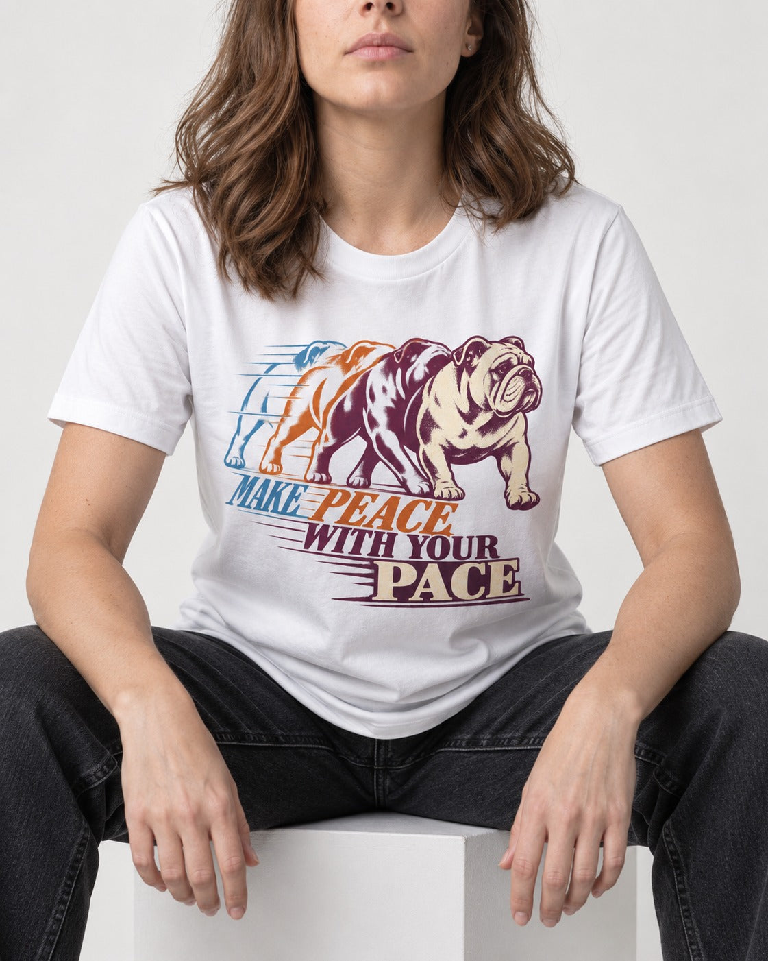 English Bulldog Peace with Your Pace T-Shirt in White, worn by a seated model