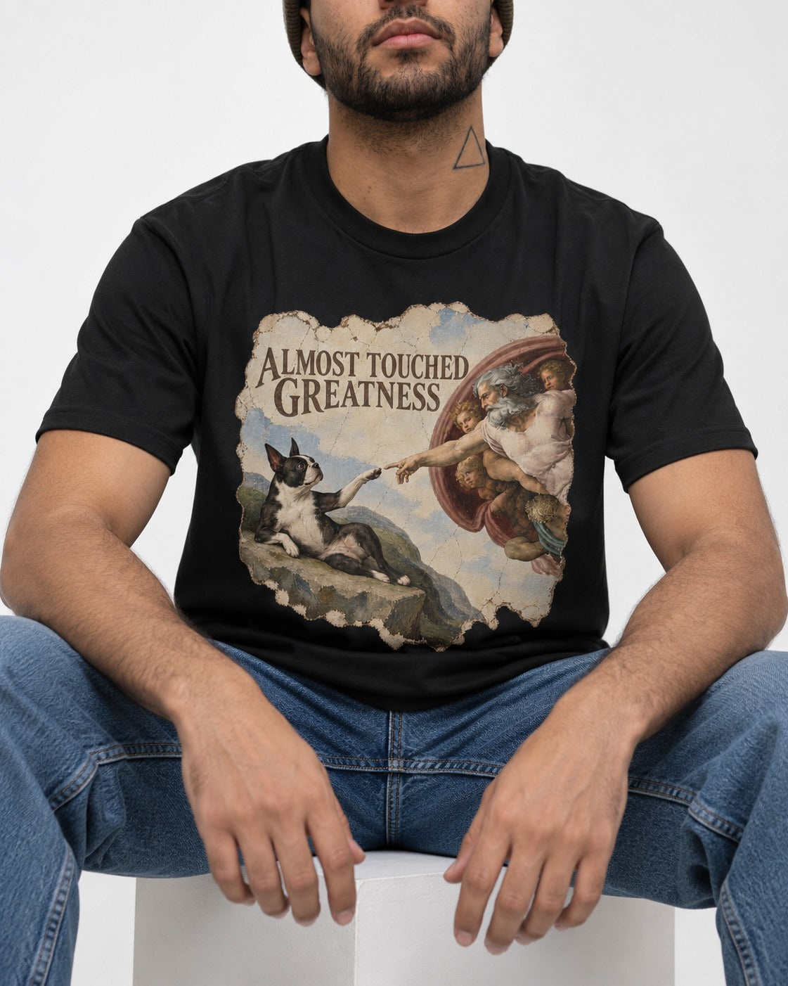 Almost Touched Greatness Boston Terrier Renaissance Parody T-Shirt in Black, worn by a seated model