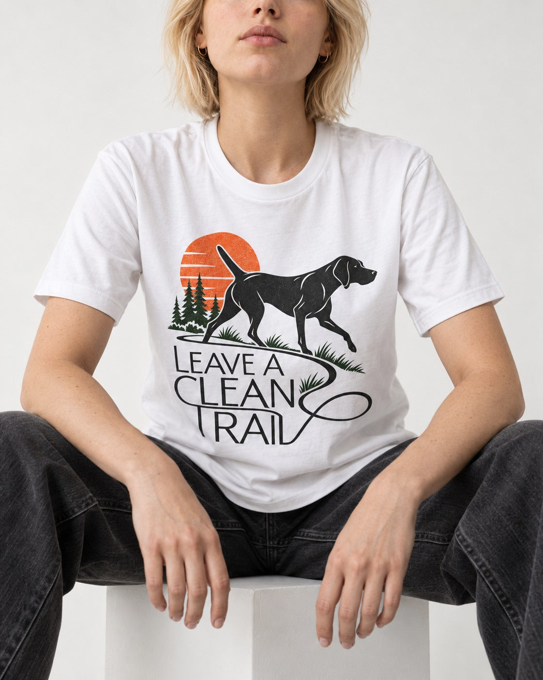 Leave a Clean Trail German Shorthaired Pointer T-Shirt in White, worn by a seated model