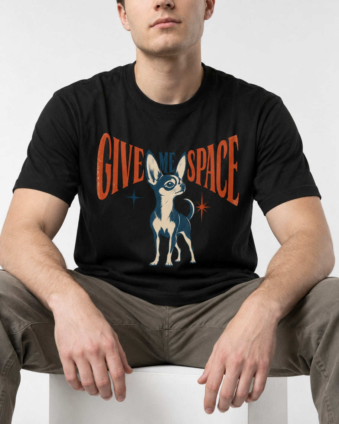 Chihuahua Give Me Space Starburst Graphic T-Shirt in Black, worn by a seated model