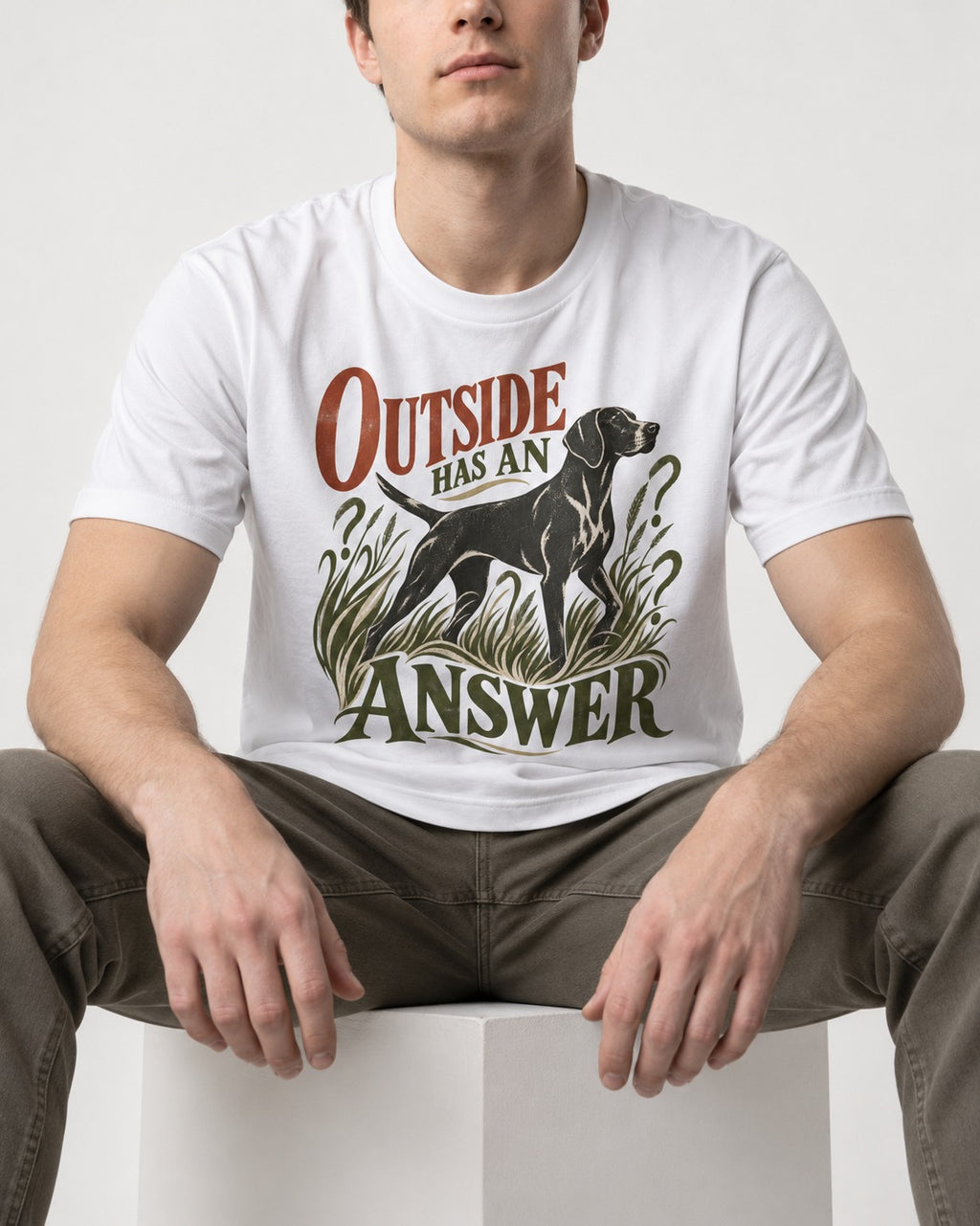 Outside Has an Answer German Shorthaired Pointer T-Shirt in White, worn by a seated model