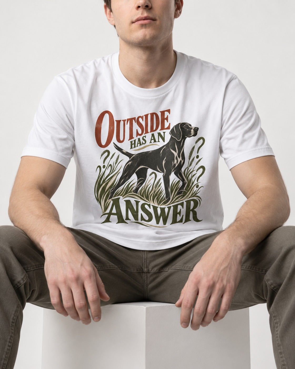 Outside Has an Answer German Shorthaired Pointer T-Shirt in White, worn by a seated model
