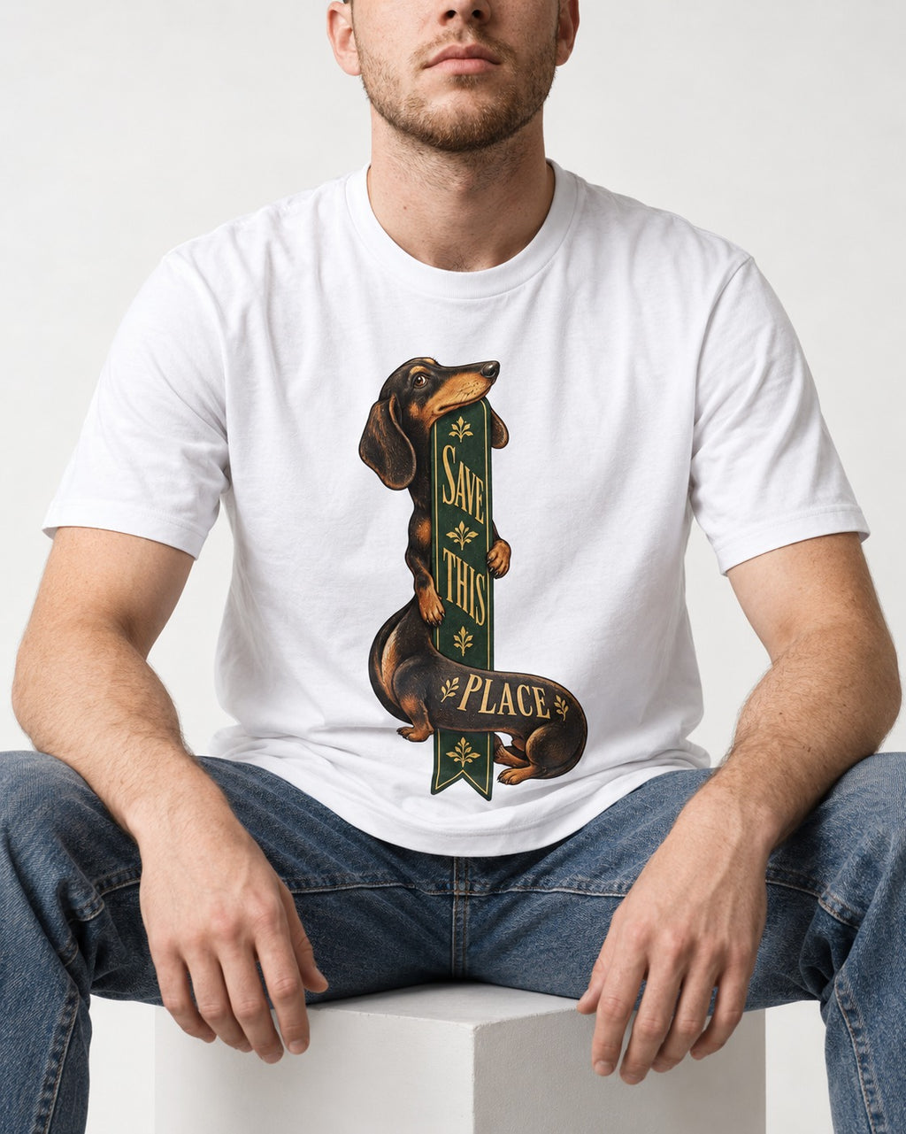 Save This Place Dachshund T-Shirt in White, worn by a seated model