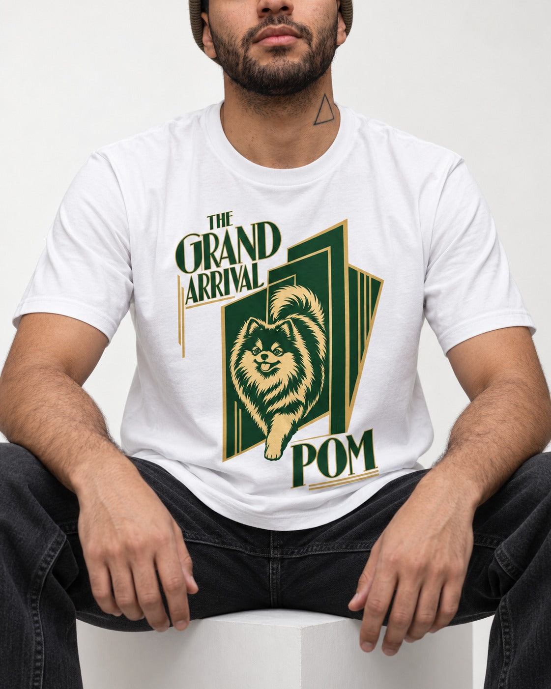 The Grand Arrival Pomeranian T-Shirt in White, worn by a seated model