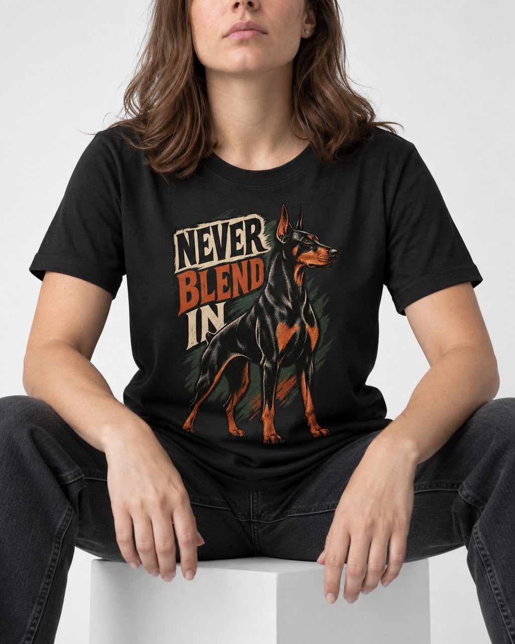 Doberman Never Blend In Brush Graphic T-Shirt in Black, worn by a seated model