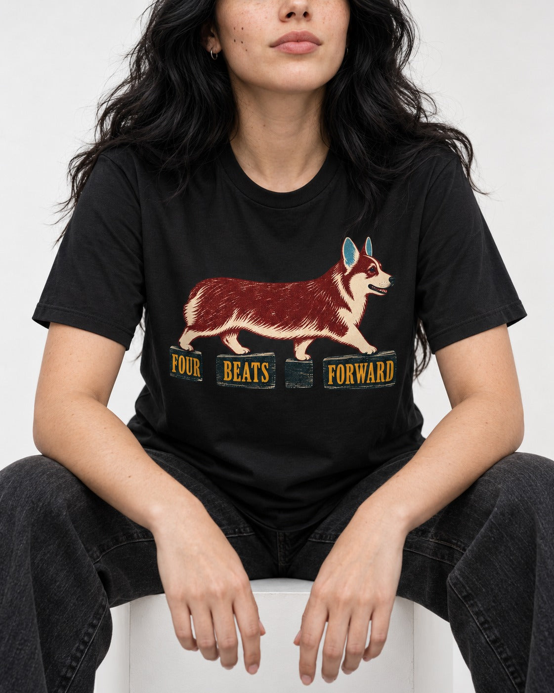 Corgi Four Beats Forward T-Shirt in Black, worn by a seated model