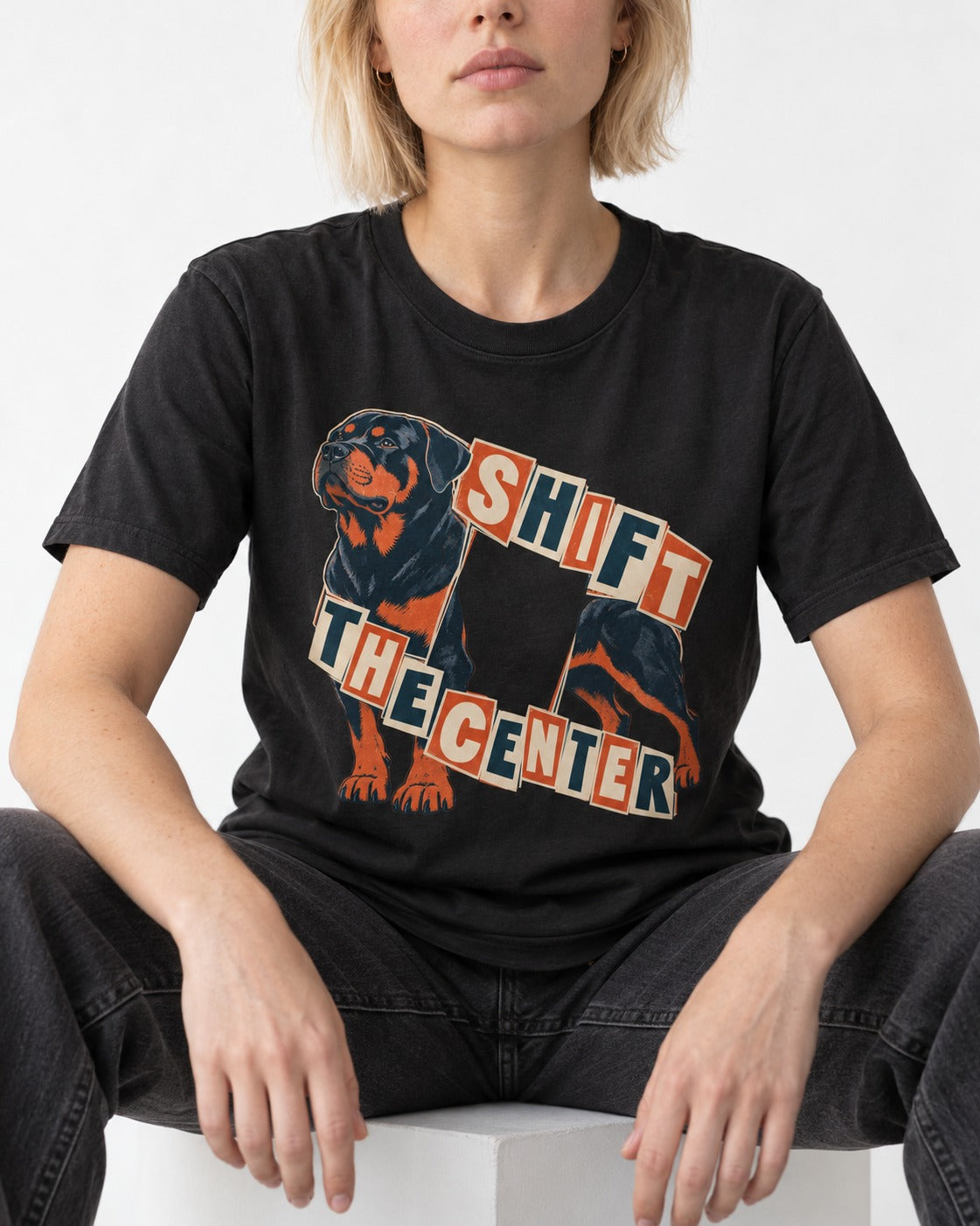 Rottweiler Shift the Center Cutout Letter Graphic T-Shirt in Black, worn by a seated model
