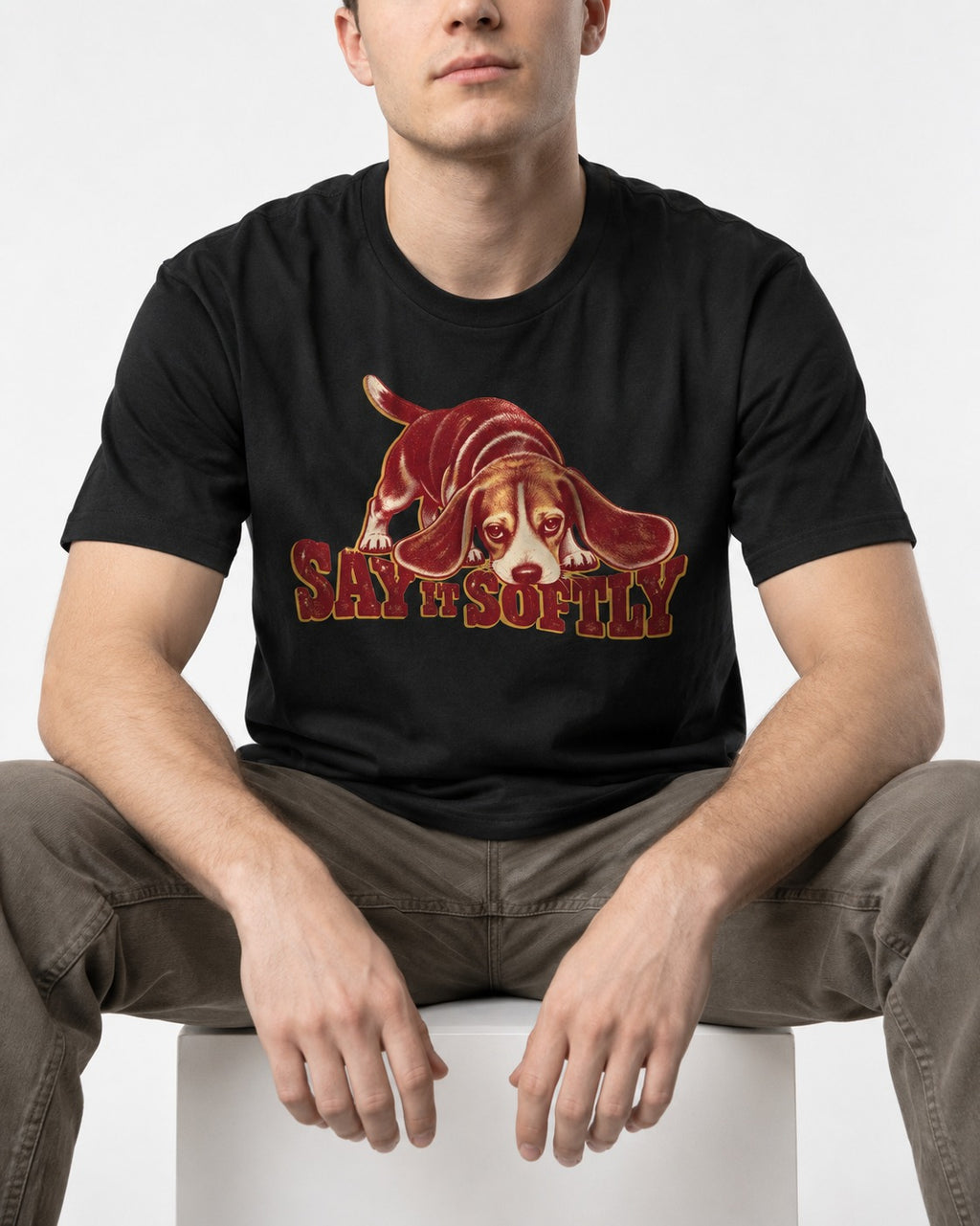 Beagle Say It Softly T-Shirt in Black, worn by a seated model