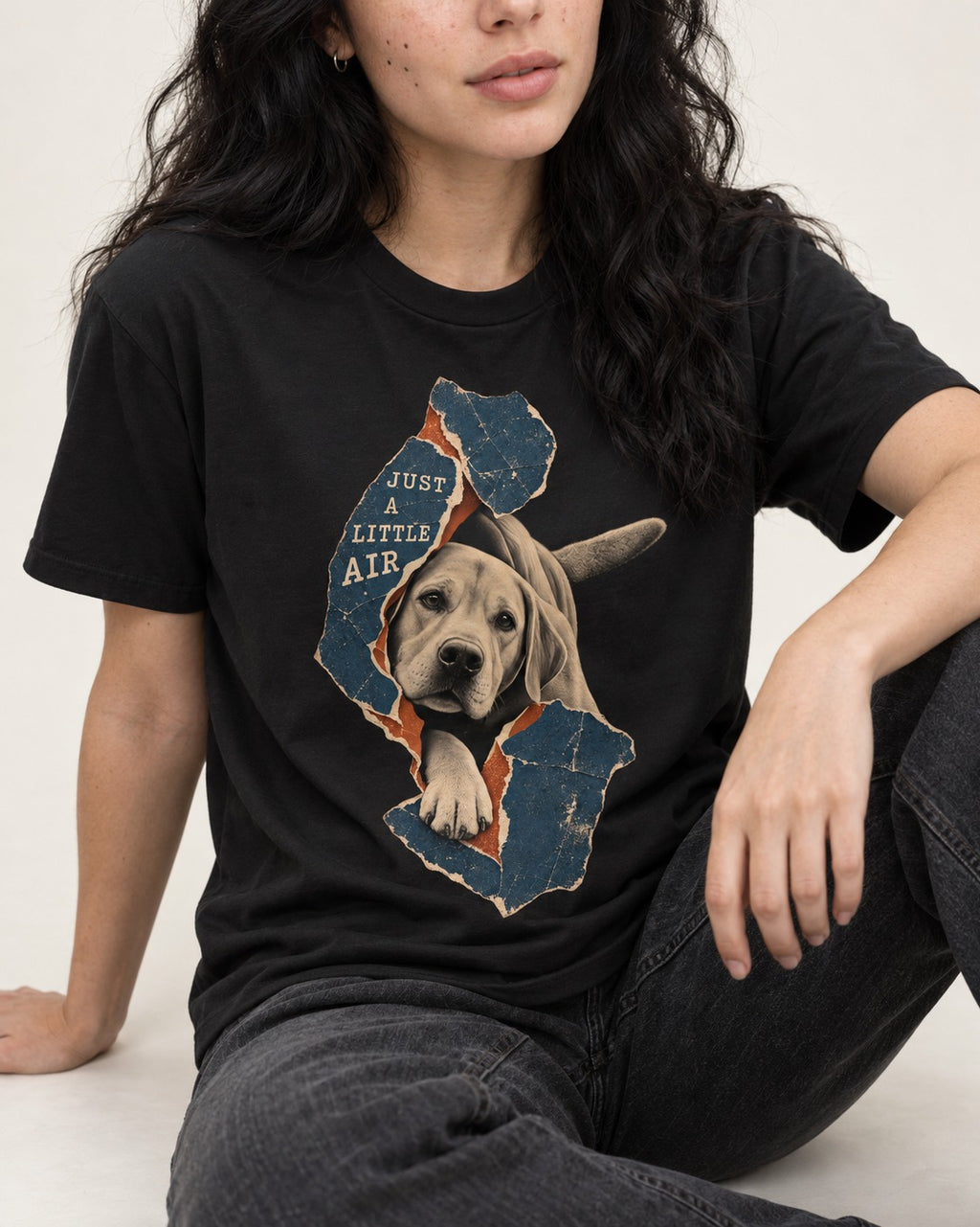 Labrador Retriever Just a Little Air Torn Paper Graphic T-Shirt in Black, worn by a seated model