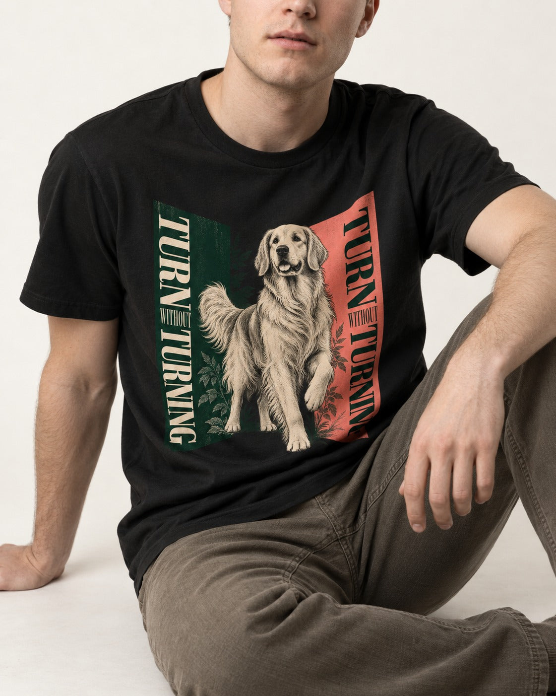 Golden Retriever Turn Without Turning Gateway Graphic T-Shirt in Black, worn by a seated model