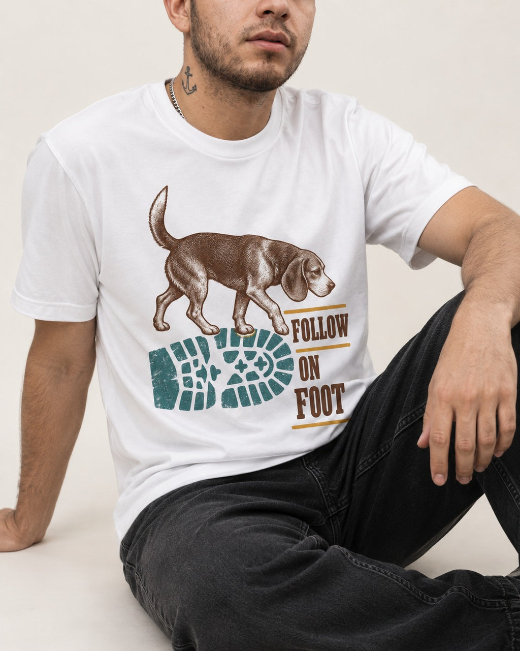 Follow the Beagle on Foot T-Shirt in White, worn by a seated model