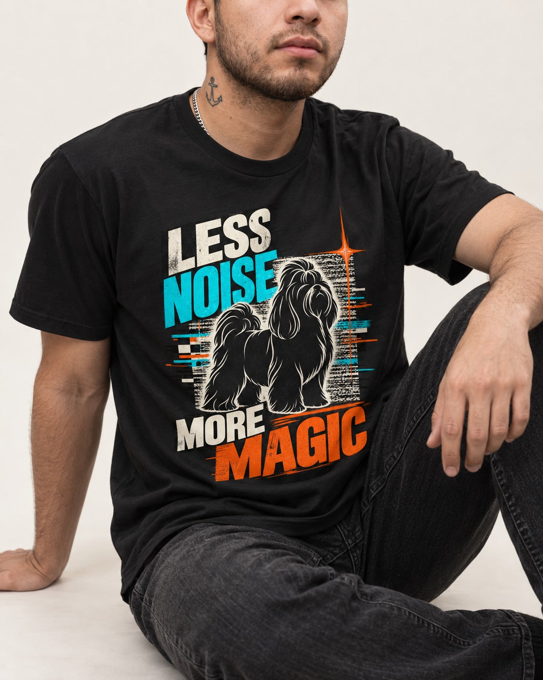 Shih Tzu Less Noise More Magic Pop Art Graphic T-Shirt in Black, worn by a seated model