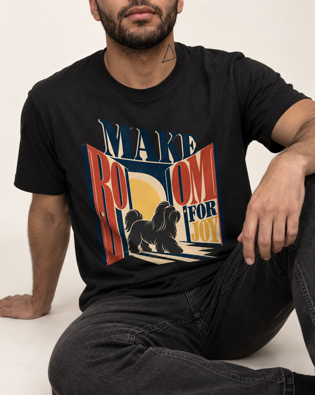 Shih Tzu Make Room for Joy Doorway Graphic T-Shirt in Black, worn by a seated model