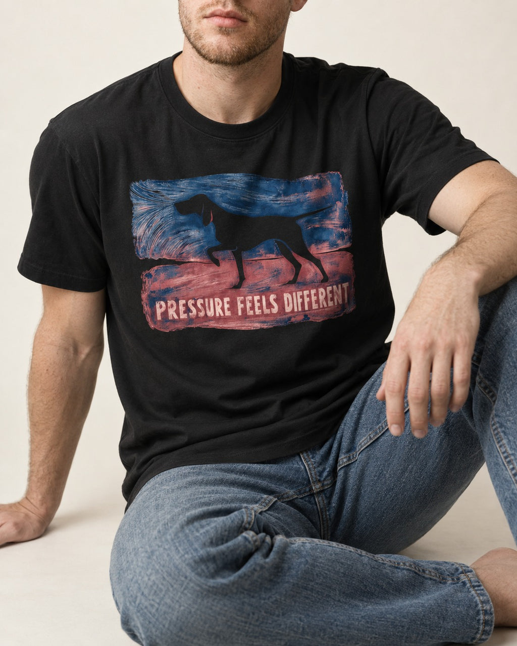 German Shorthaired Pointer Pressure Feels Different Monotype Graphic T-Shirt in Black, worn by a seated model