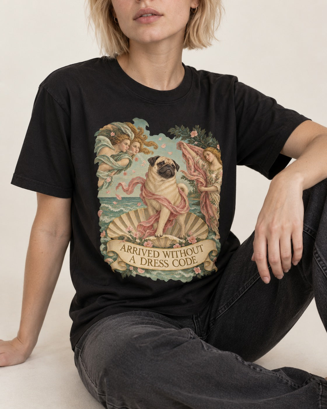 Pug Arrived Without a Dress Code Venus Parody Graphic T-Shirt in Black, worn by a seated model