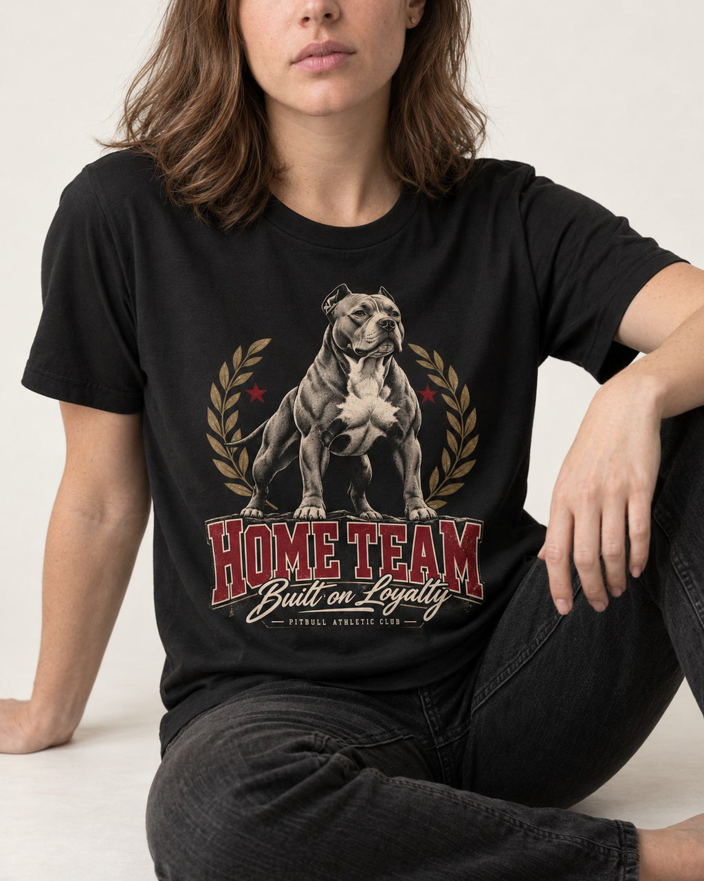 Pitbull Home Team Loyalty Crest Graphic T-Shirt in Black, worn by a seated model