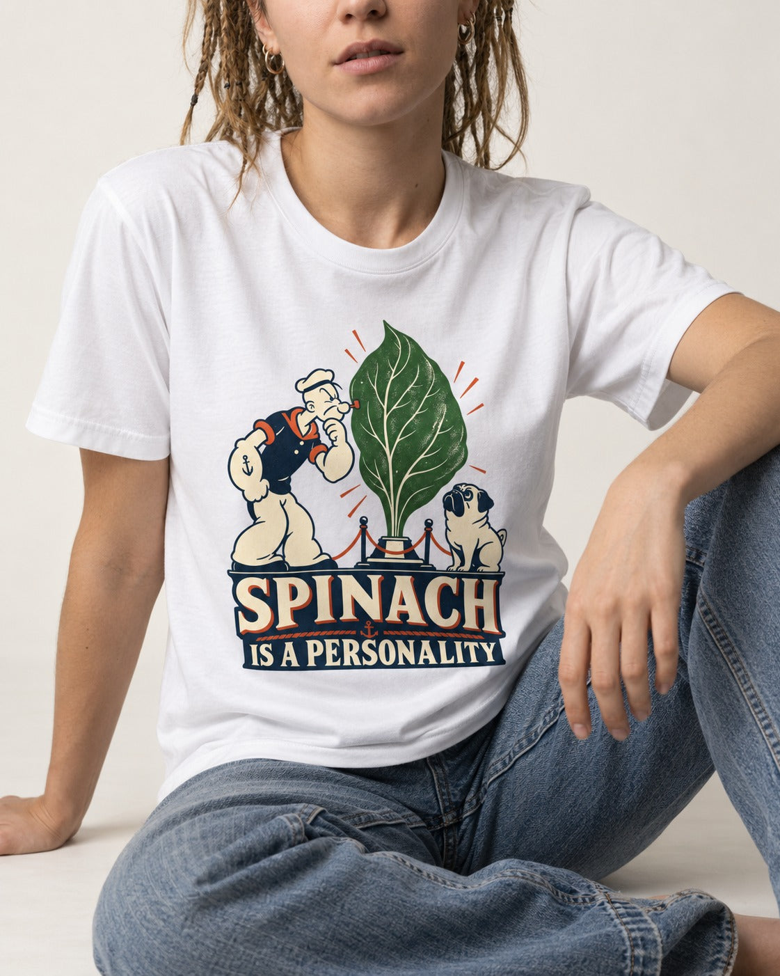Pug Spinach Is a Personality T-Shirt in White, worn by a seated model