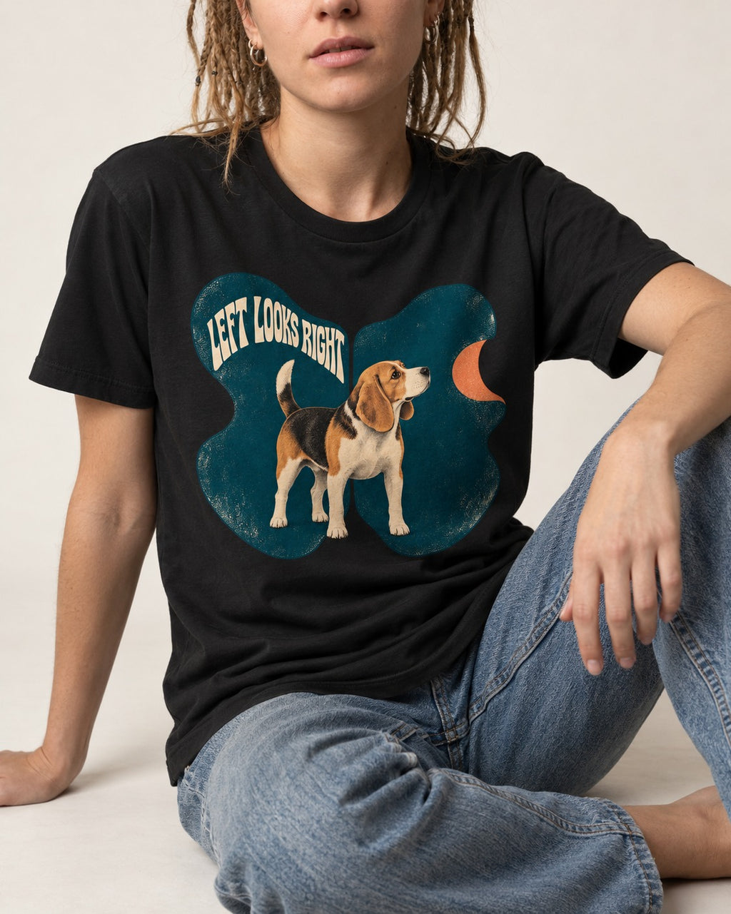 Left Looks Right Beagle Abstract Shapes T-Shirt in Black, worn by a seated model