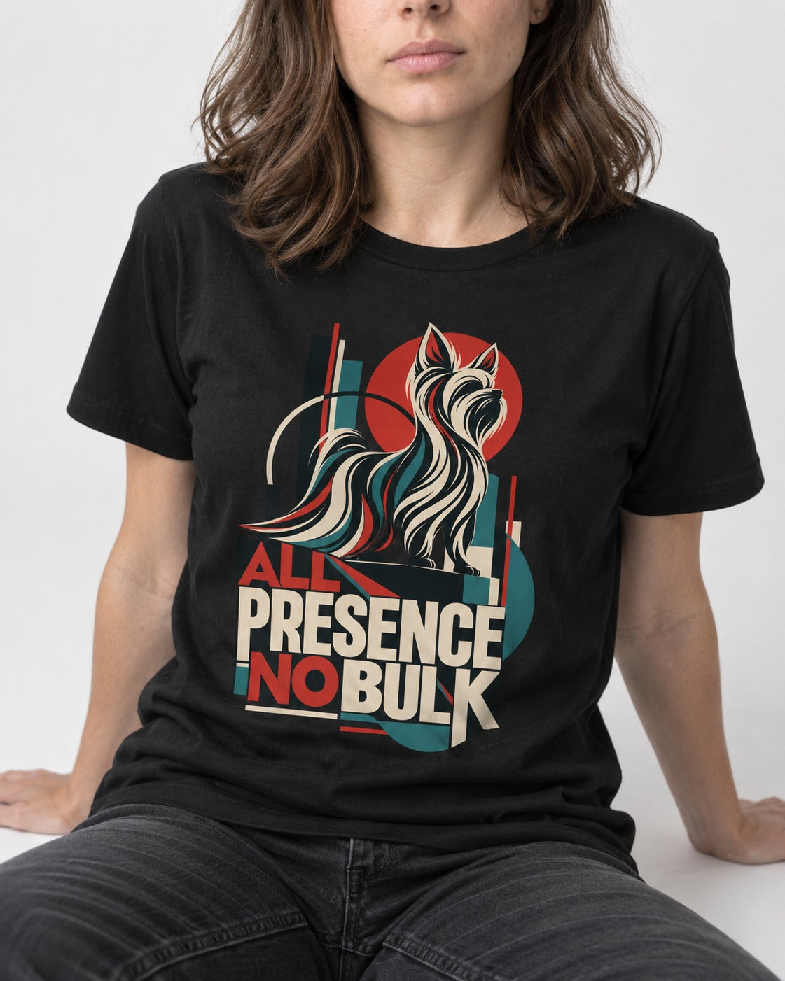 Yorkshire Terrier All Presence No Bulk Geometric Portrait Graphic T-Shirt in Black, worn by a seated model