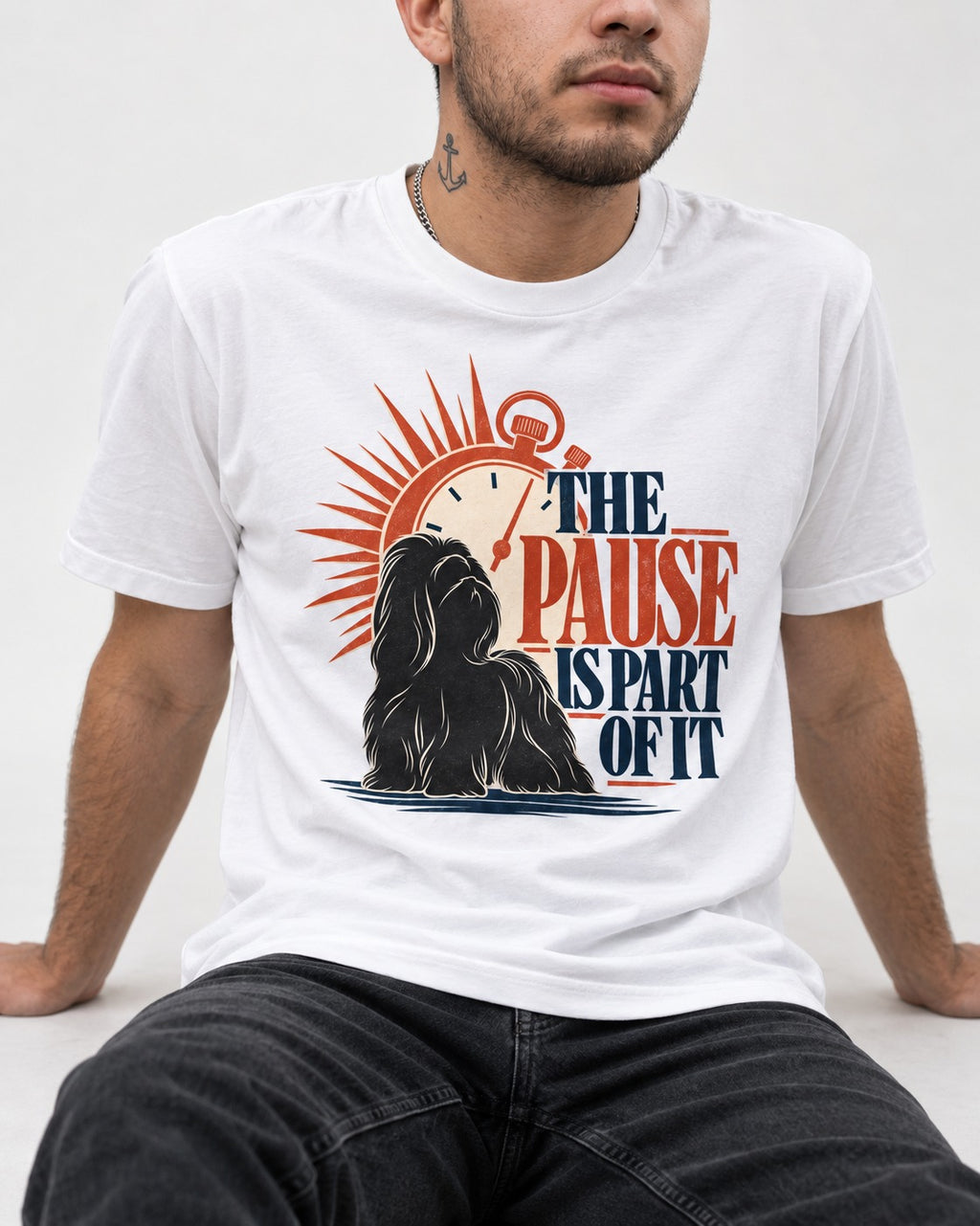 The Shih Tzu Pause T-Shirt in White, worn by a seated model