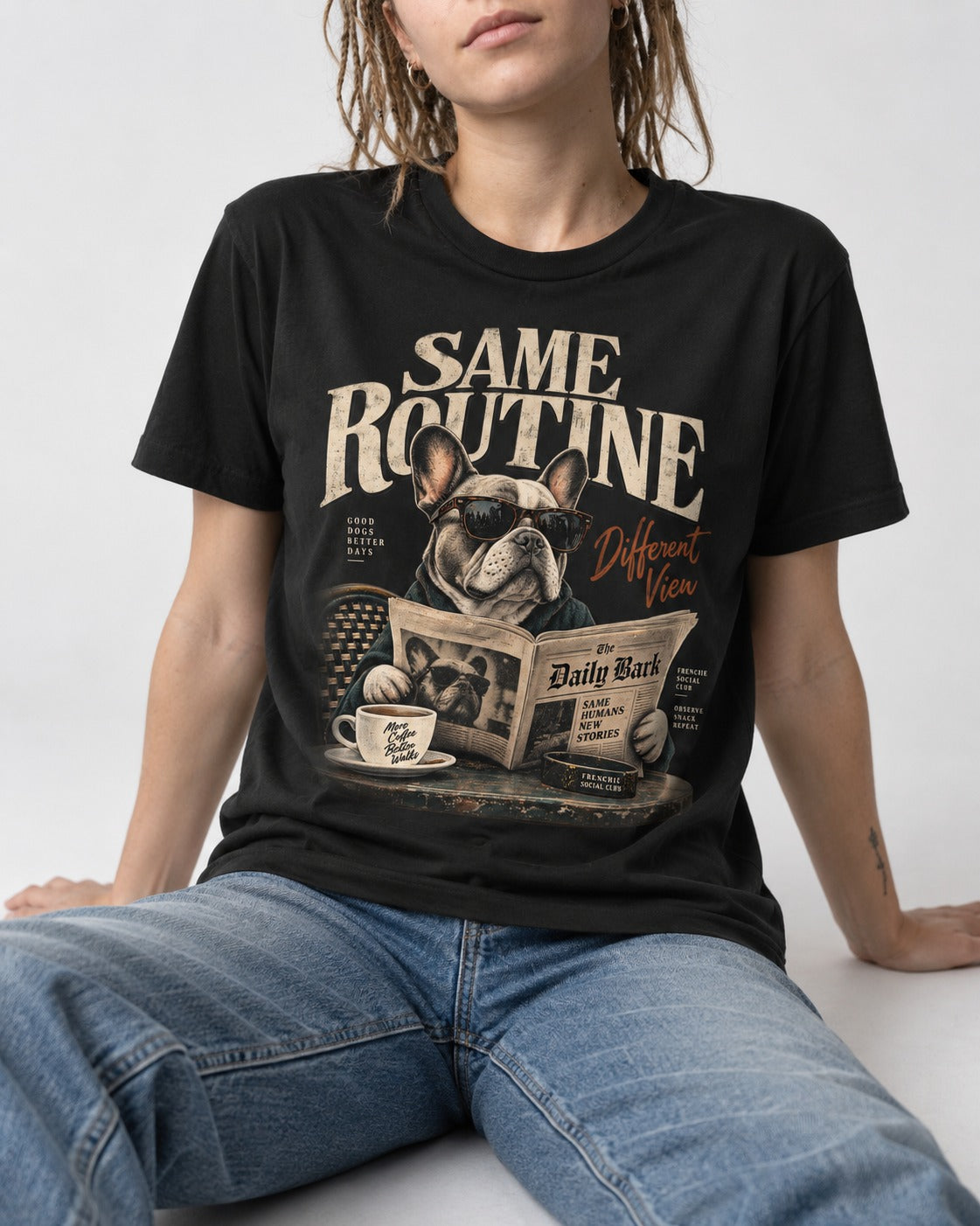 Frenchie Same Routine Different View Graphic T-Shirt in Black, worn by a seated model