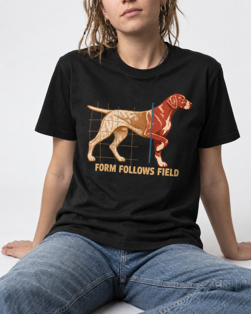 German Shorthaired Pointer Form Follows Field Grid Graphic T-Shirt in Black, worn by a seated model