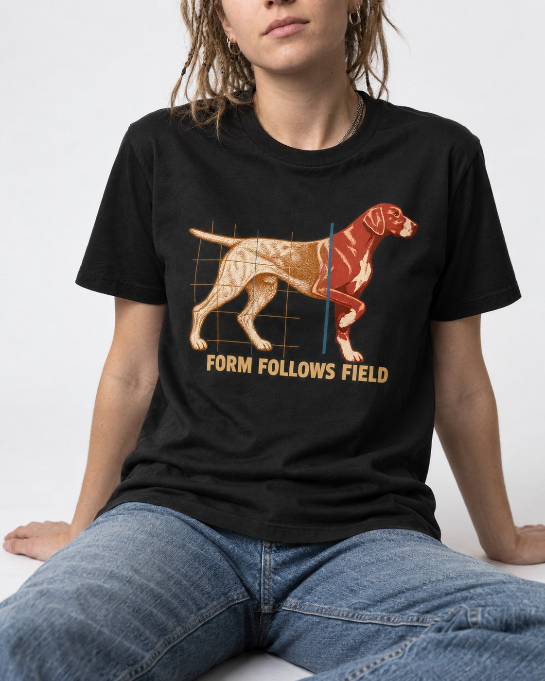 German Shorthaired Pointer Form Follows Field Grid Graphic T-Shirt in Black, worn by a seated model