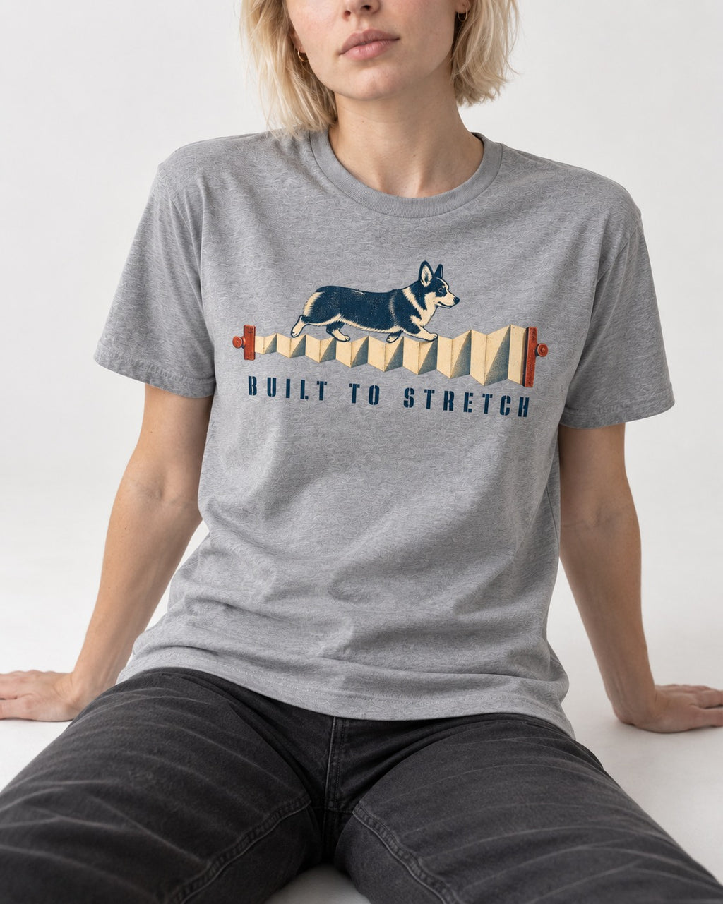 Corgi Built to Stretch Accordion Graphic T-Shirt in Sport Grey, worn by a seated model