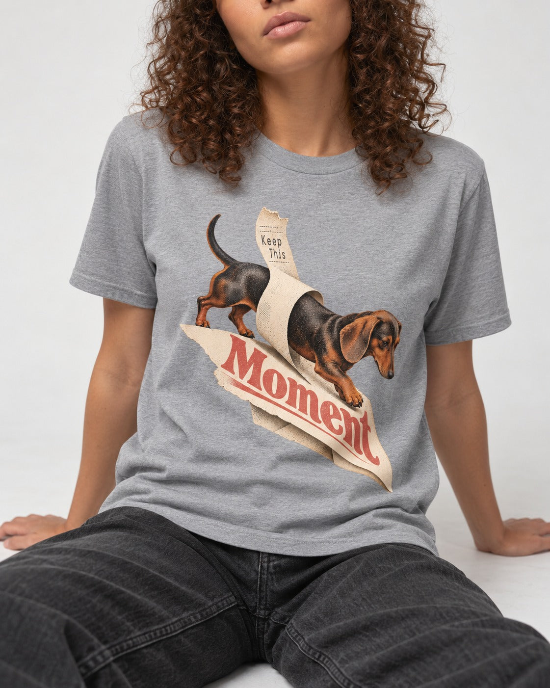 Dachshund Keep This Moment Receipt Graphic T-Shirt in Sport Grey, worn by a seated model