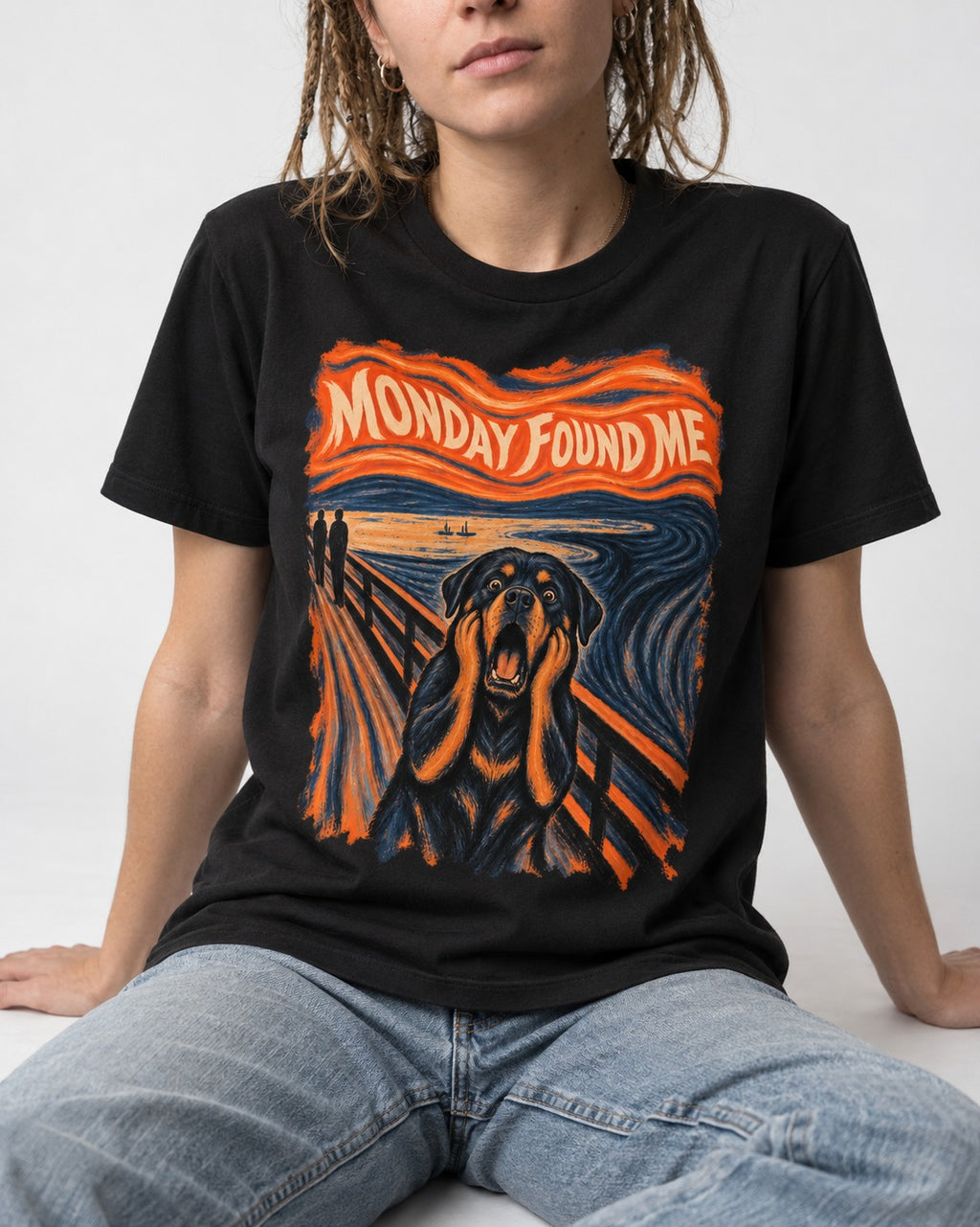 Rottweiler Monday Found Me Scream Parody Graphic T-Shirt in Black, worn by a seated model