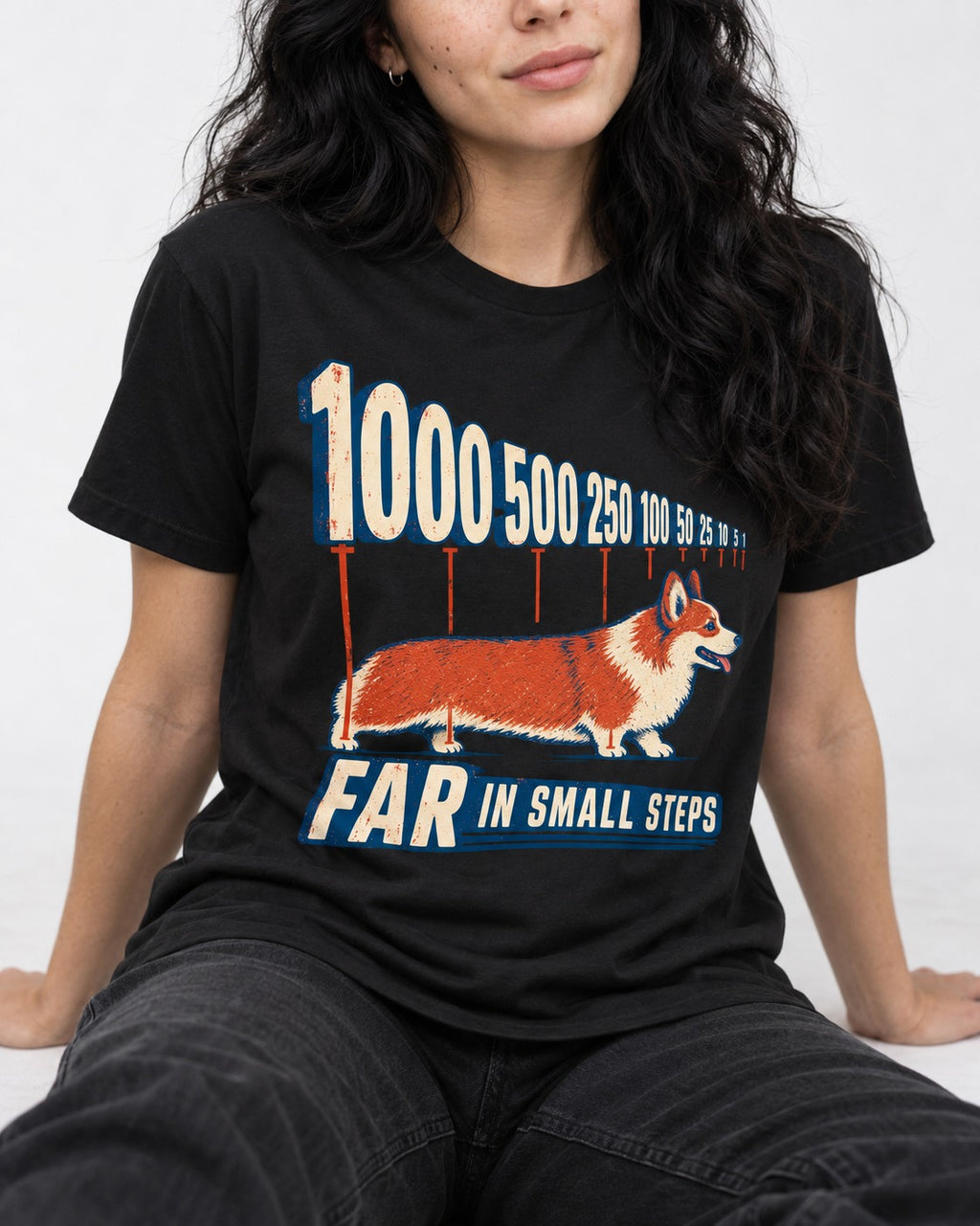 Corgi Far in Small Steps T-Shirt in Black, worn by a seated model