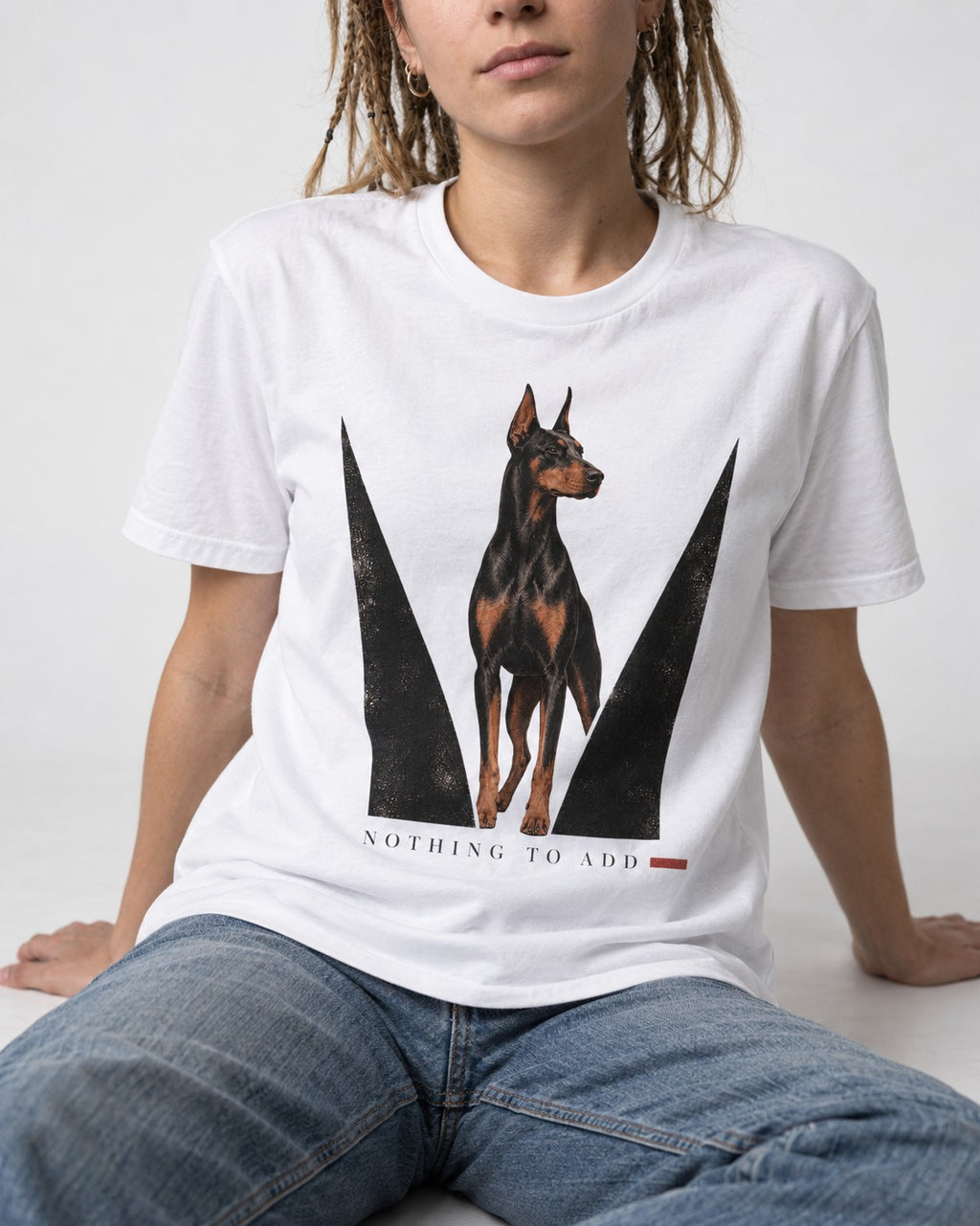 Doberman Nothing to Add T-Shirt in White, worn by a seated model
