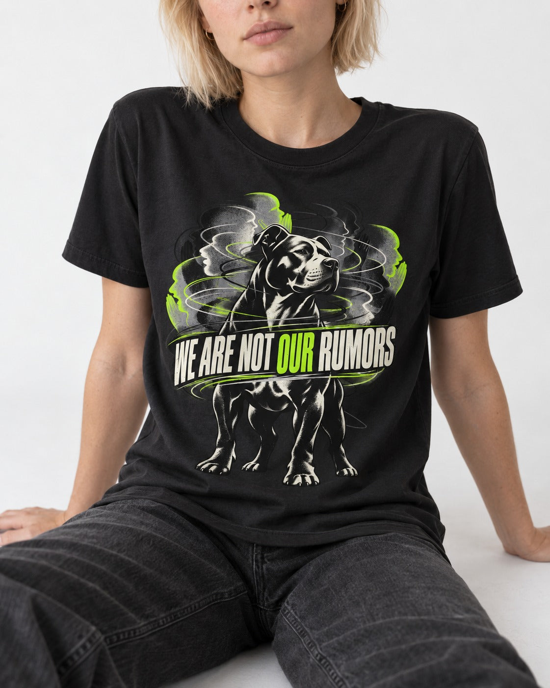 Pitbull We Are Not Our Rumors Swirling Voices Graphic T-Shirt in Black, worn by a seated model
