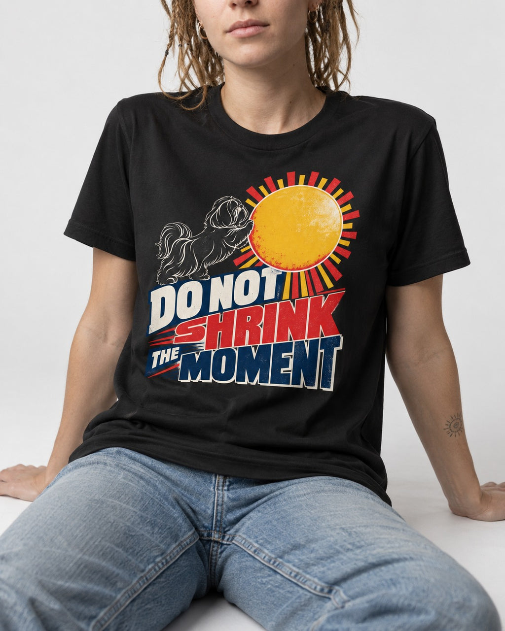Shih Tzu Do Not Shrink the Moment Sun Graphic T-Shirt in Black, worn by a seated model