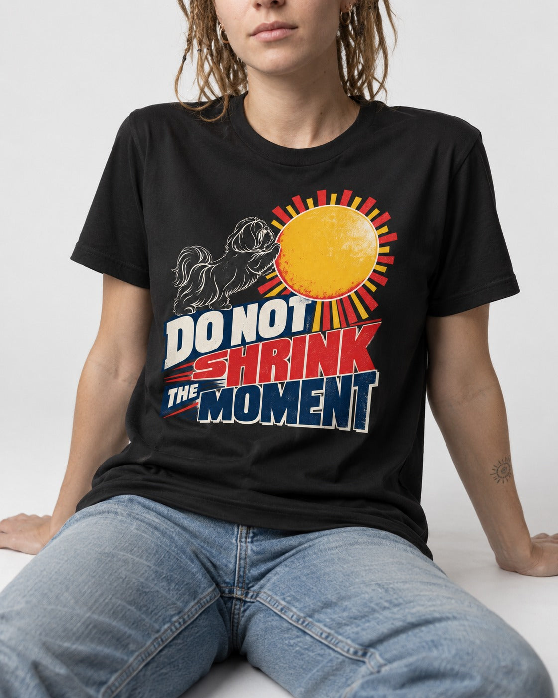 Shih Tzu Do Not Shrink the Moment Sun Graphic T-Shirt in Black, worn by a seated model