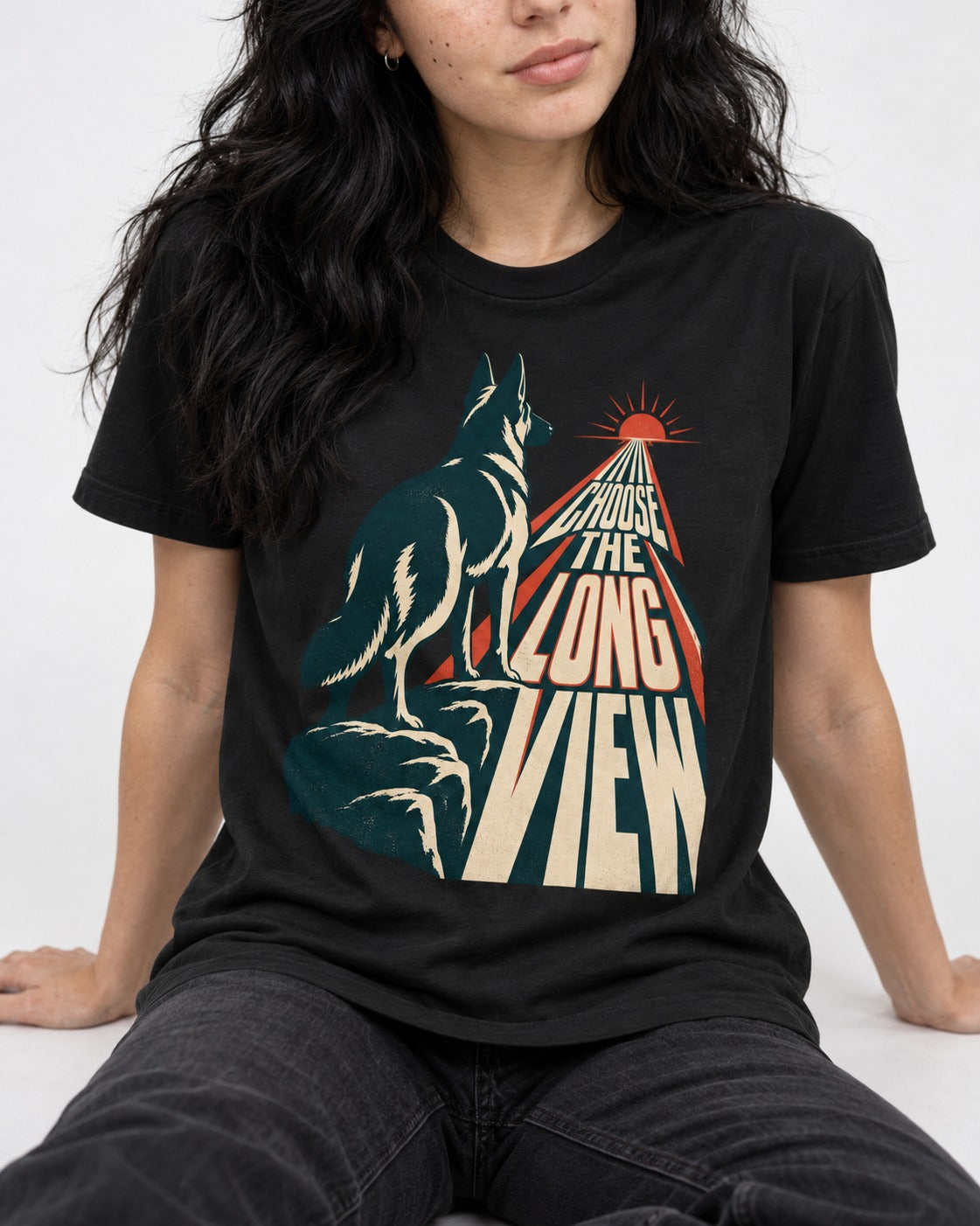 Choose the Long View Sunrise German Shepherd Dog Graphic T-Shirt in Black, worn by a seated model