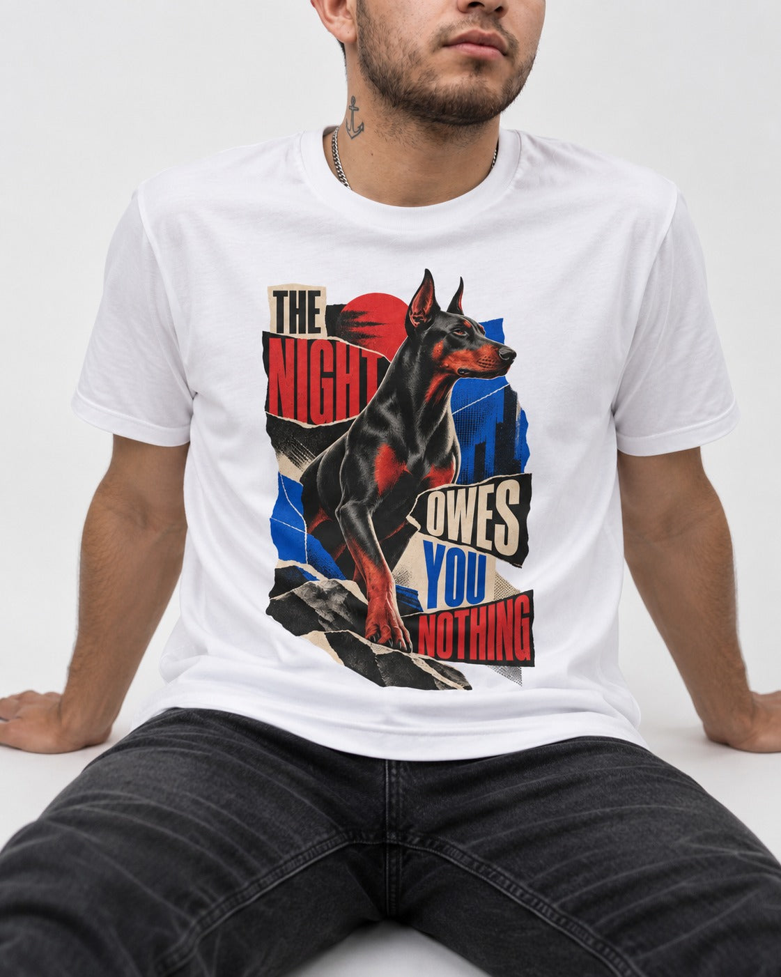 Night Owes You Nothing Doberman T-Shirt in White, worn by a seated model