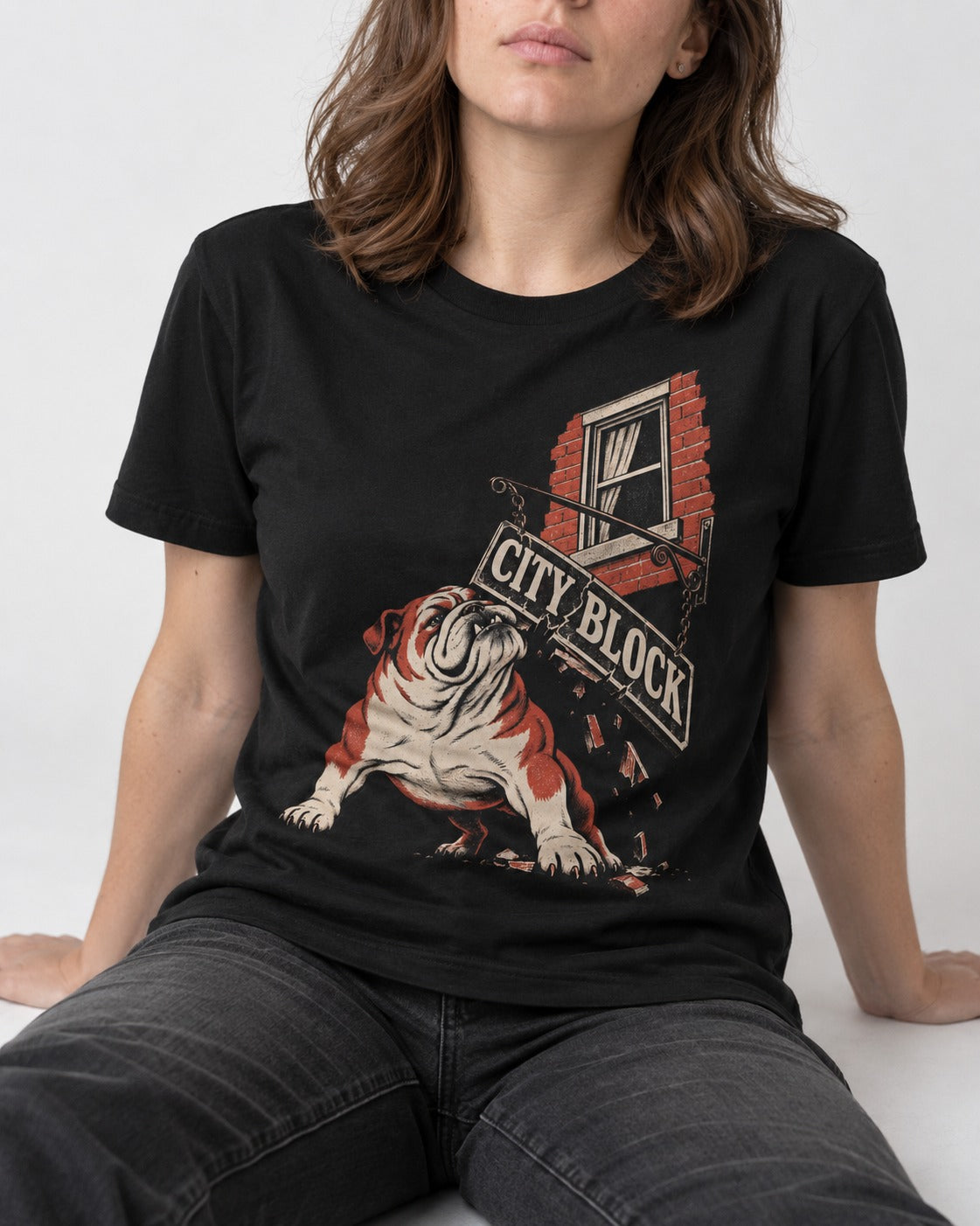 English Bulldog City Block Breaking Sign Graphic T-Shirt in Black, worn by a seated model