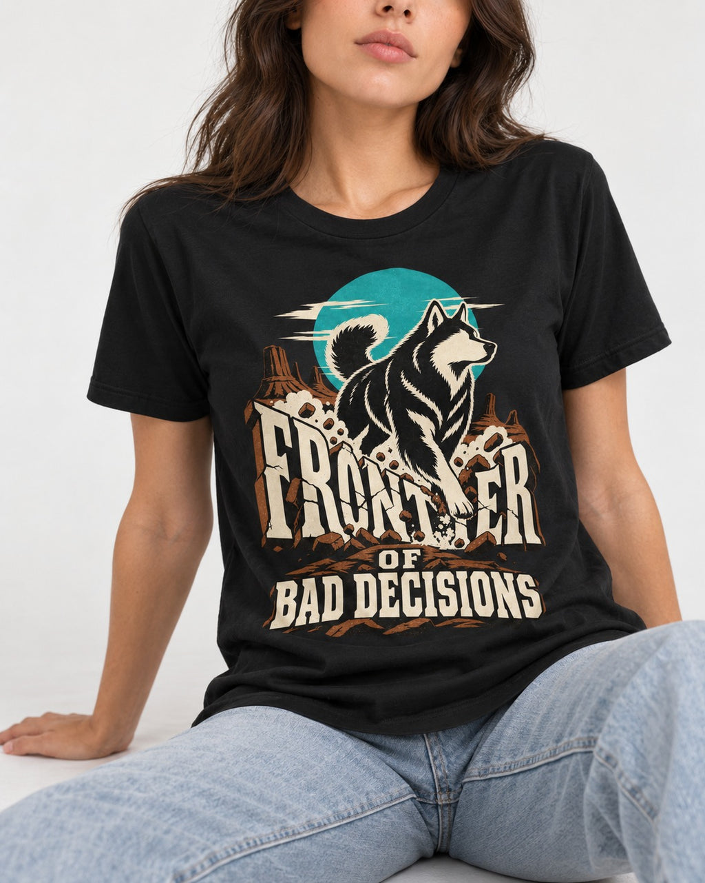 Husky Frontier of Bad Decisions Desert Graphic T-Shirt in Black, worn by a seated model