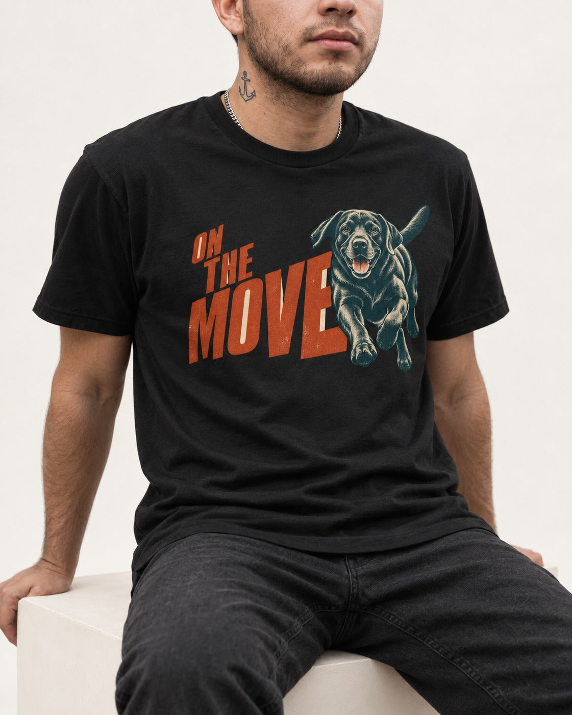 Labrador Retriever On the Move Running Graphic T-Shirt in Black, worn by a seated model