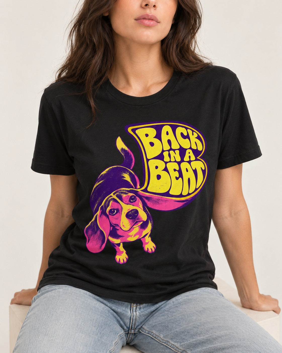 Groovy Beagle Back In A Beat T-Shirt in Black, worn by a seated model